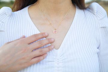 Caucasian young girl wearing necklace.