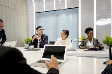 Group of diverse businesspeople at conference, happy business workers discussing and brainstorming together at meeting room. Cheerful officers exchange ideas and listen to presentations during meeting