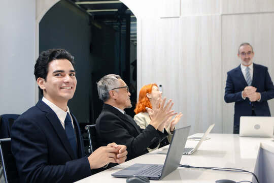 Group of diverse businesspeople at conference. Cheerful officer exchange ideas and listen to presentations during meeting. Audiences clapping hands to appreciate after speaker finished presentation.