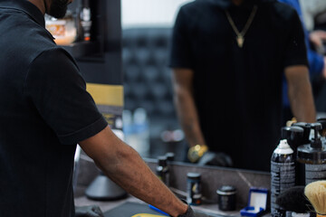 Barber Reaching for Tools in Mirror Reflection