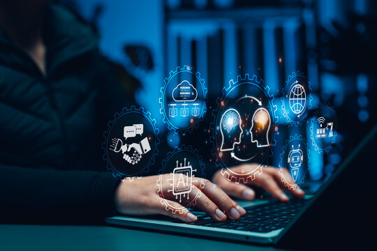 Human and AI Knowledge Transfer and Collaboration Concept. Person using laptop with icons showing human brain and AI brain, symbolizing artificial intelligence, machine learning and knowledge exchange - Powered by Adobe
