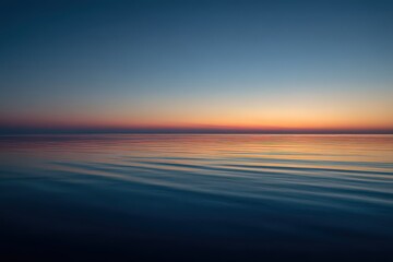 Obraz premium Serene Ocean at Dusk with Golden Horizon Reflection Water Surface Ripples and Cloudless Sky Gradient Color Spectrum Tranquil Scenery and Natural Illumination