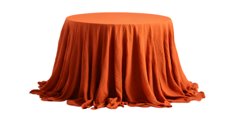 Orange draped fabric covering a round table against a black background