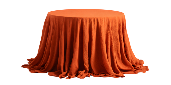 Orange draped fabric covering a round table against a black background