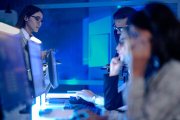 Data integrity check night shift Diverse team meticulously audits financial performance comparing figures tablet screen printed reports ensuring accuracy crucial validation process underway hub.