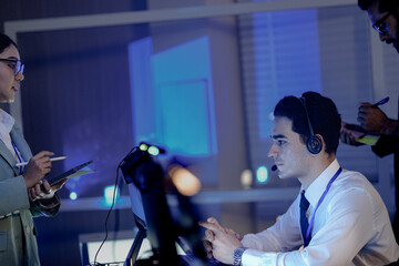 Peak synergy unlocked late night tech hub Diverse professionals collaborate intense discussion tablet data screens glow focused team drives project success forward together now energy boost.