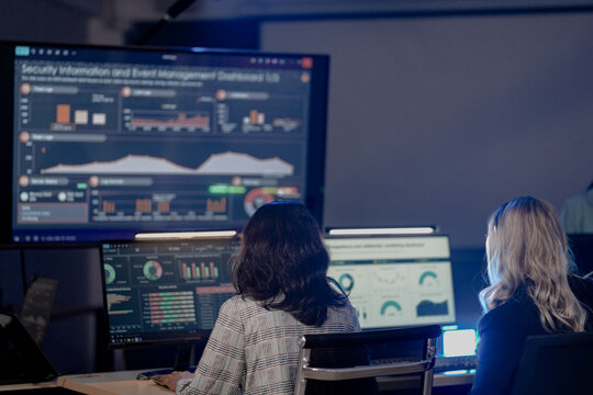 Global security watch active Diverse analysts monitor world map threat intel screens leader coordinates response strategy critical vigilance protects assets worldwide team focus now protect.