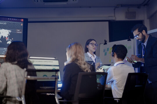 Future mission control synergy Diverse team leverages AI predictive insights interactive screens guide complex operations leader directs augmented human AI team achieve optimal results faster now.