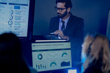 Intense focus unlocked. Professional man glasses suit interacts tablet stylus late night modern...