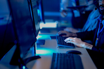 High stakes finance night. Diverse male and female analysts track volatile global markets, intense focus monitor screens real time data, critical decisions hedge fund trading floor.