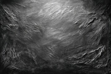 Dramatic textured dark surface shows a rough and uneven terrain with peaks and valleys, resembling a rugged landscape