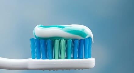 White and blue toothpaste on blue and green toothbrush bristles dental hygiene oral care