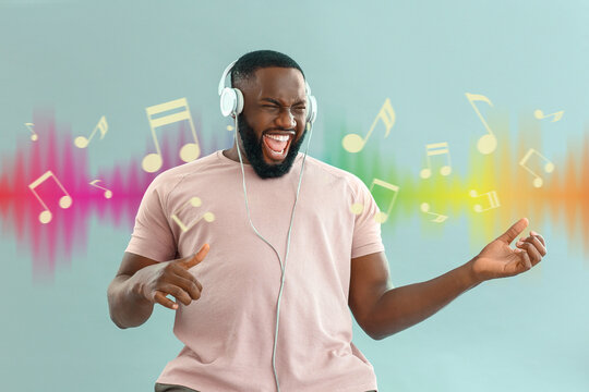 Emotional African-American man listening to music on color background - Powered by Adobe
