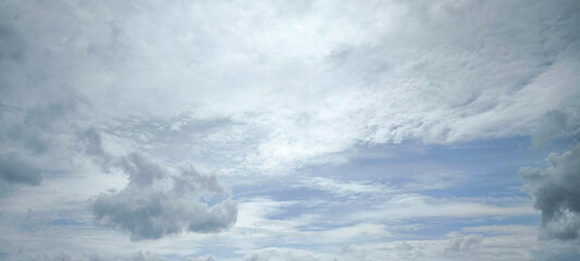 Fototapeta premium Scattered white clouds in a clear blue sky. Sky and cloud landscape. Sky background.