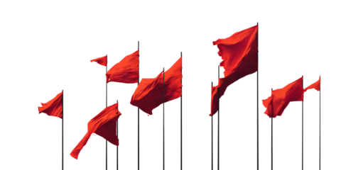 Multiple red flags waving against a dark background