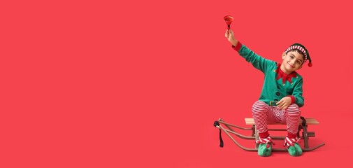 Cute little elf with sled and Christmas bell on red background with space for text