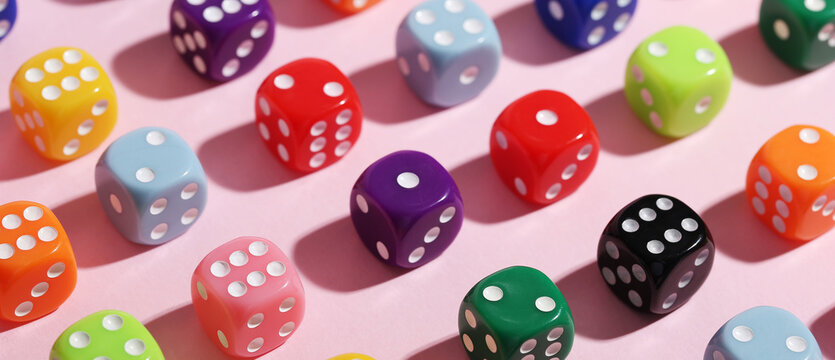 Many game dices on pink background