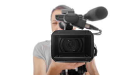 A professional videographer holding a video camera while recording, viewed from the front lens perspective on a white background.