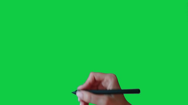 A woman's hand draws a cross with a stylus. Female hand gesture drawing with stylus on chroma key green screen background. Girl's hand guesture with stylus: crossing out, negation, deletion, say no