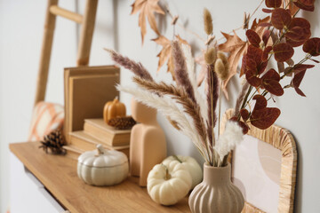 Vase with pampas grass on chest of drawers in room, closeup