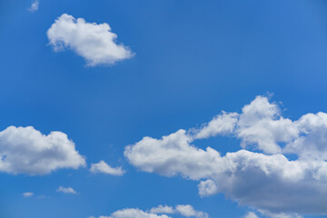 Beautiful fluffy clouds in a clear blue sky during a sunny day