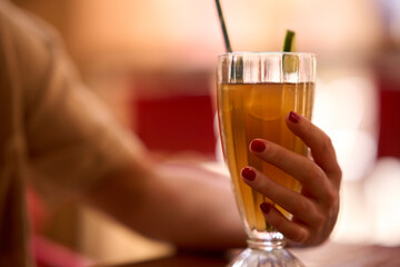 Female hand holding a mule glass