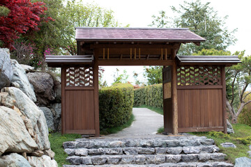 
Japanese Garden Gate with Stone Steps and Lush Greenery