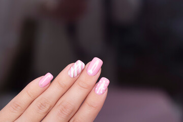 Beautiful female hands with fashion manicure nails, white gel polish, heart design