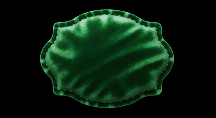 Close up of a vibrant green velvet cushion with a decorative scalloped edge and subtle marbled pattern against a dark background