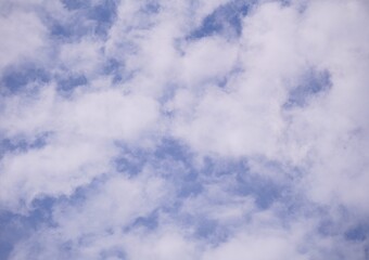 Fluffy White Clouds Drifting Across a Vivid Blue Sky.