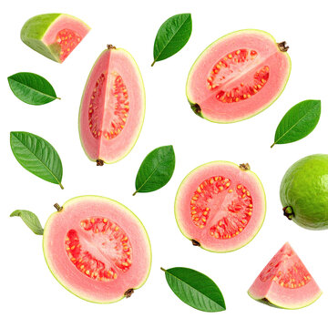 Overhead shot of guava fruits (cut & whole) with leaves scattered on black background