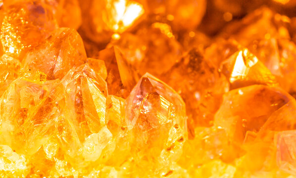 Golden crystal mineral stone. Gems. Mineral crystals in the natural environment. Texture of precious and semiprecious stones. Seamless background with copy space.