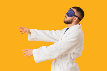 Male sleepwalker on yellow background