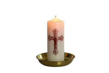 A lit white pillar candle with a prominent red crucifix design, standing in a golden brass holder, isolated on a solid background. background removed