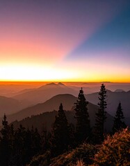 Hiker celebrates sunset from mountain peak in the Alps, enjoying stunning views and nature's beauty during golden hour