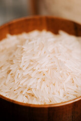 Long grain white rice in a wooden bowl ready for cooking