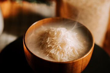 Long grain white rice steaming in a wooden bowl ready for a delicious meal