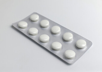 White tablets in a blister pack on a clean surface
