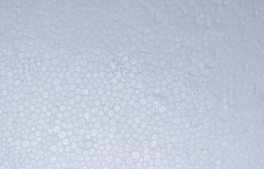 Texture of white styrofoam, close-up of fine foam surface