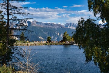 Crans Montana. Beautiful view of the Crans Montana lettering banner, Valais, Switzerland. In the background, high snow-covered mountains. Swiss Alps landscape. High quality photo.