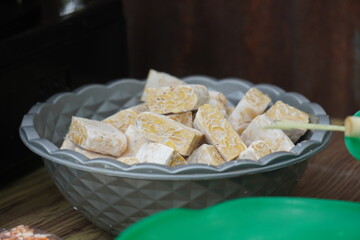 Raw Tempeh Cubes in Bowl Ready for Healthy Meal Preparation.