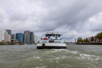 Sailing inland vessel in Rotterdam with the Willemsbrug in the background