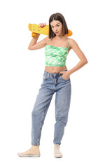 Obraz premium Young woman with skateboard on white background