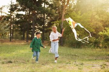 Fototapeta premium Children with kite running in park