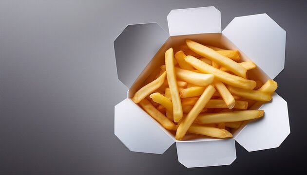 french fries in a white cardboard box on a grey paper background with ample copy space for inserting images can be used for mock ups