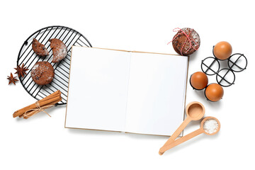 Blank recipe book with Christmas cookies, cinnamon and eggs on white background
