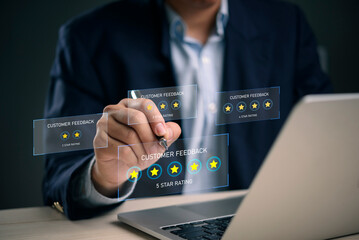 Man hand writing 5 star review customer feedback hologram. Online survey satisfaction evaluation. Best service quality positive. Businessman technology digital interface laptop work dark background.