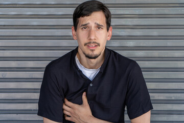 Young man having severe chest pain heart attack