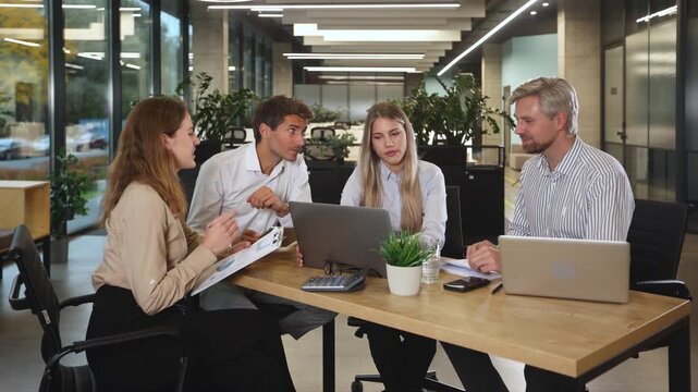 Group of happy progressive business people working on startup together at creative office