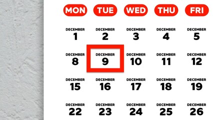 Close-up of the date December 9th marked with a red cursor on the wall calendar 2025